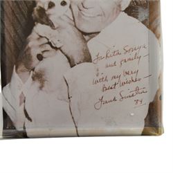 Frank Sinatra signed black and white photograph, the image depicting the singer holding a puppy, signed to the bottom right corner 'To Rita, Soraya and family, with my love and best wishes Frank Sinatra 84'

By venodr repute: signed 'To Rita, Soraya and family' - Rita was the vendor's mother. Sinatra signed the photograph after his 1984 performance at the Royal Albert Hall; his agent Harold Davison was married to the singer Marion Ryan who was a friend of Rita.