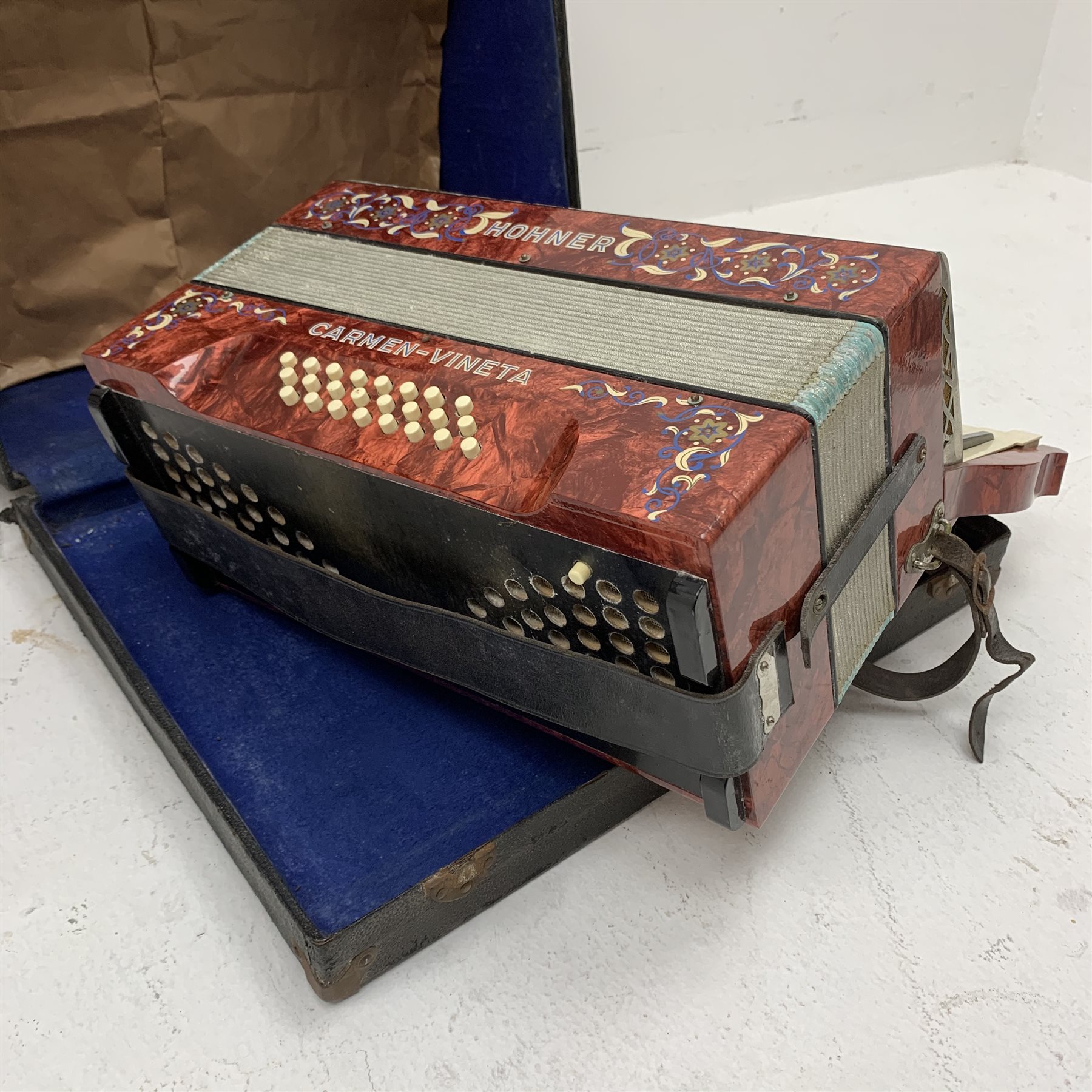  RTV - German Hohner Carmen-Vineta piano accordion with decorative red pearline finish, twenty keys and twenty-four buttons W24cm in carrying case  