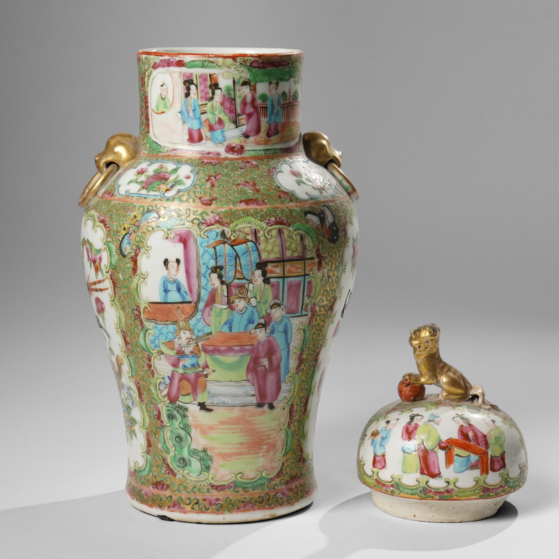 Cantonese famille rose vases, of inverted baluster form, the domed cover with gilt dog of Fu finial, H38cm; together with a further pair of Cantonese vases, each with double Buddhist lion handles and applied at the shoulders with chilong, H45cm (3)