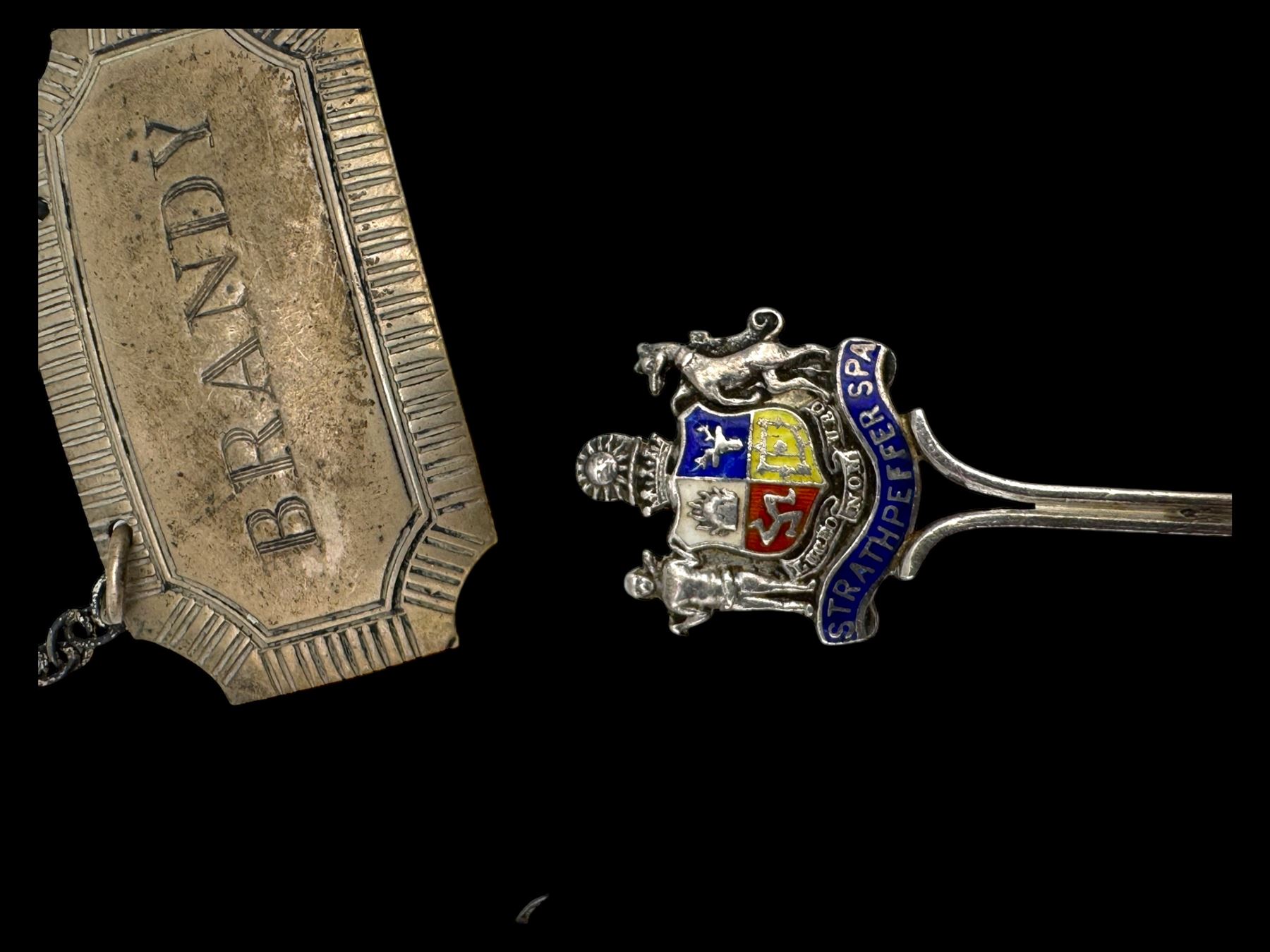 Three silver decanter labels and a collection of silver and silver plated cutlery