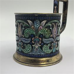 Mid 20th century Russian silver and cloisonné enamel cup, of cylindrical form upon short flared foot, the body and tall flat capped handled decorated in polychrome stylised foliage, bearing marks including right facing Kokoshnik mark with district number and mint marks for St. Petersburg, including handle H9.5cm D7cm