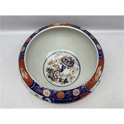 Late 19th century Japanese Imari jardinière of fishbowl form, decorated with shaped panels of stylised flowers, blossom and foliate motifs with gilding throughout above a blue and white geometric pattern band, the interior decorated with roundel of a bonsai tree in pot, with character mark beneath, H21.5cm D37cm