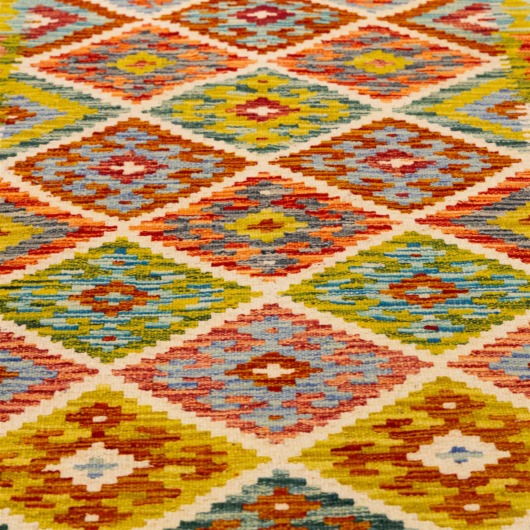 Turkish Anatolian flatweave kilim, ivory field decorated with rows of large stepped lozenge medallions enclosing stylized geometric motifs flanked by narrow geometric side panels, fringe ends 