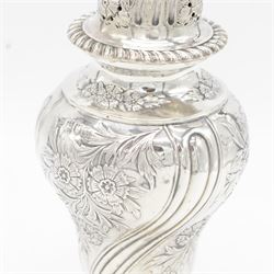Edwardian silver sugar caster, of typical form embossed with floral decoration, the removable pierced cover with oblique gadrooned rim and bud finial, upon a circular stepped foot, hallmarked Hawksworth, Eyre & Co Ltd, London 1901, H20cm