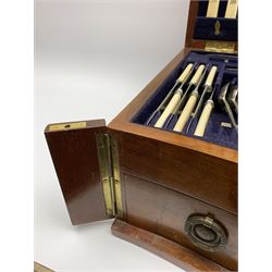 Late 19th/early 20th century composite canteen of silver flatware, contained within an early 20th century mahogany serpentine fronted case with twin drop carry handles, and hinged cover with boxwood stringing and central inlaid shell motif, above a single drawer with twin ring handles and Wellington style locking system, the cover and drawer opening to reveal plaque for Spink & Sons Ltd London, and fitted interior containing ivory handled knives, ivory handled carving set, and silver Hanoverian and Old English pattern cutlery, each with engraved monogram to terminal, hallmarked London, makers Spink & Son (John Marshall Spink), Goldsmiths & Silversmiths Co, and Chawner & Co (George William Adams), various dates ranging 1880-1923, gross weighable silver 92.59 ozt (2880 grams)