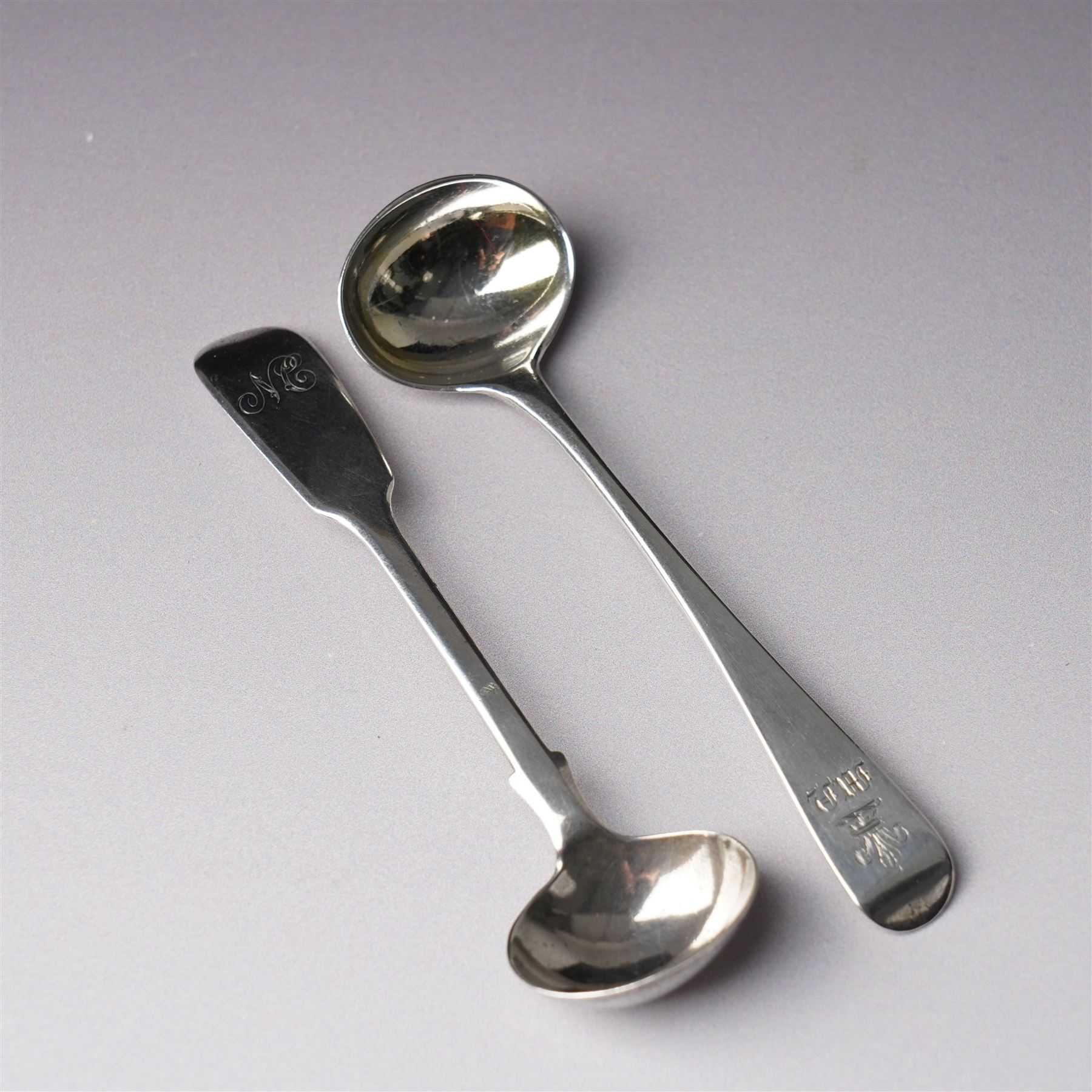 Pair of George III silver circular salts with gilded interiors and embossed decoration and two 19th century condiment spoons, one by Peter and Ann Bateman 