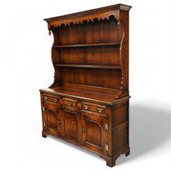 Gostins of Liverpool - Georgian design oak dresser, the two-tier rack with moulded cornice over shaped frieze and end supports, the dresser base with moulded rectangular top over tree drawers and two cupboards, panelled sides, on bracket feet