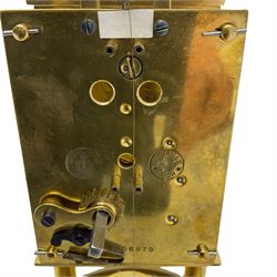 Gustav Becker 400-day torsion clock, serial No 2056379, with an adjustable rotary torsion pendulum and intact suspension, with a circular brass base and glass dome, cream enamel dial with roman numerals, minute markers and steel spade hands.

