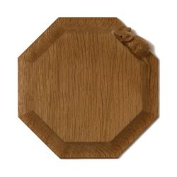 Mouseman - small octagonal oak chopping board/tea pot stand by Robert Thompson of Kilburn, with carved mouse signature, D19cm 

Generously donated by Robert Thompson’s Craftsmen Ltd