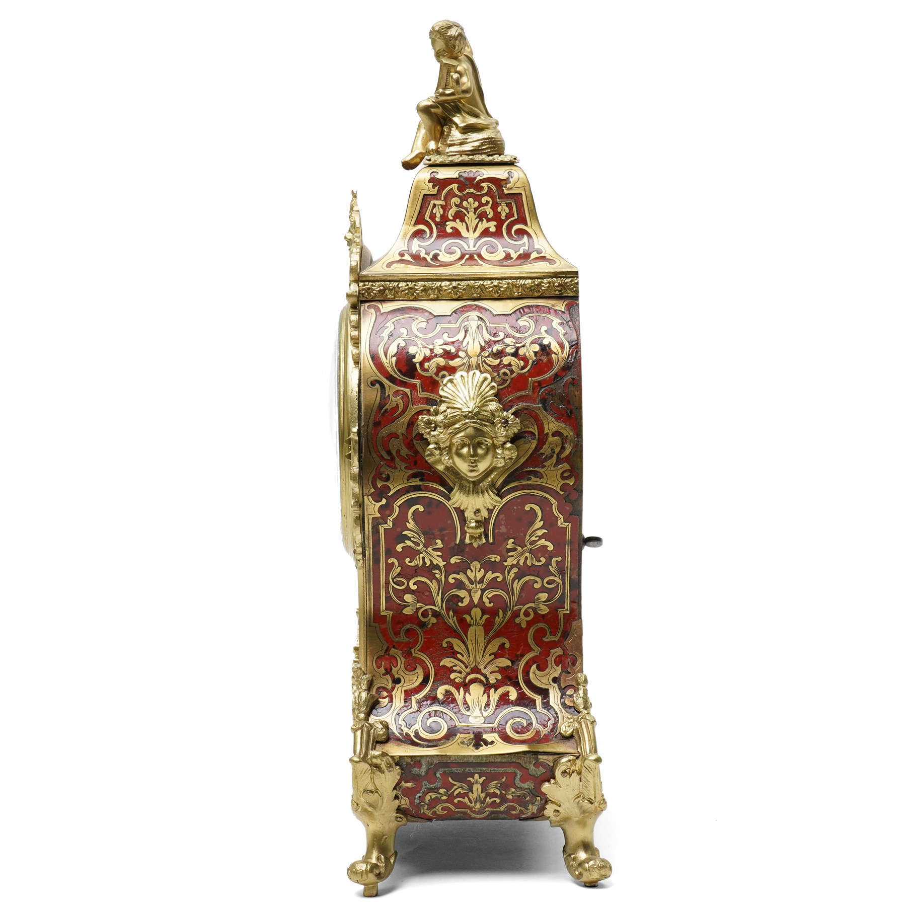 Rollin à Paris - 19th century French Louis XV style ormolu-mounted red tortoiseshell and brass Boulle-work mantel clock, surmounted by a seated musical putto above a waisted case applied with mask, rocaille, foliate and dolphin mounts, the gilt dial with white enamel Roman numeral cartouches, twin-train movement striking on a bell, signed and numbered 480, on four scrolling foliate feet