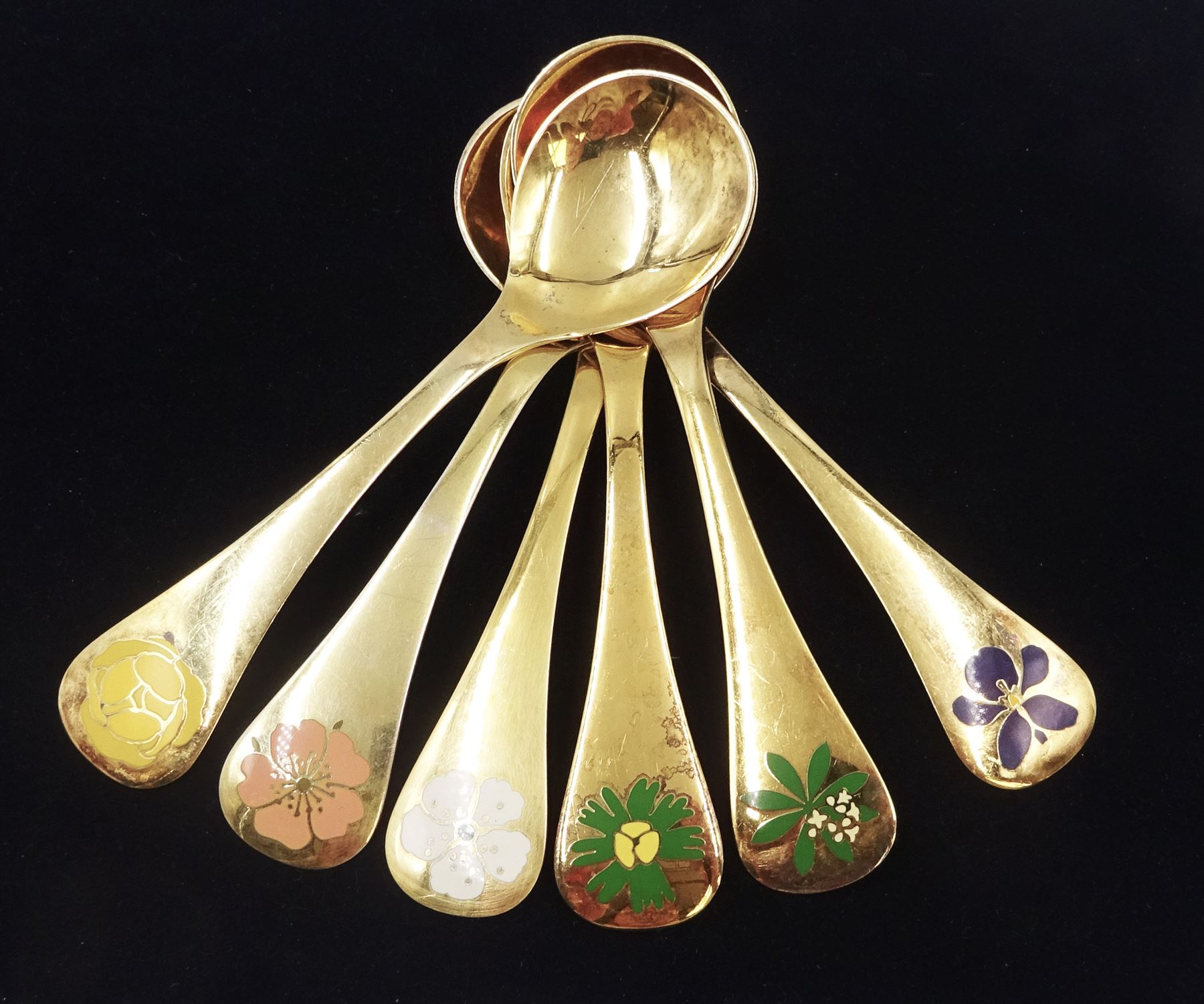 Six Danish silver-gilt year spoons by Georg Jensen, each decorated with different floral motif including Iris, Globe Flower and Waldmeister, dated between 1971 and 1982, each impressed on underside RA AB, Sterling Denmark, and marked for Georg Jensen