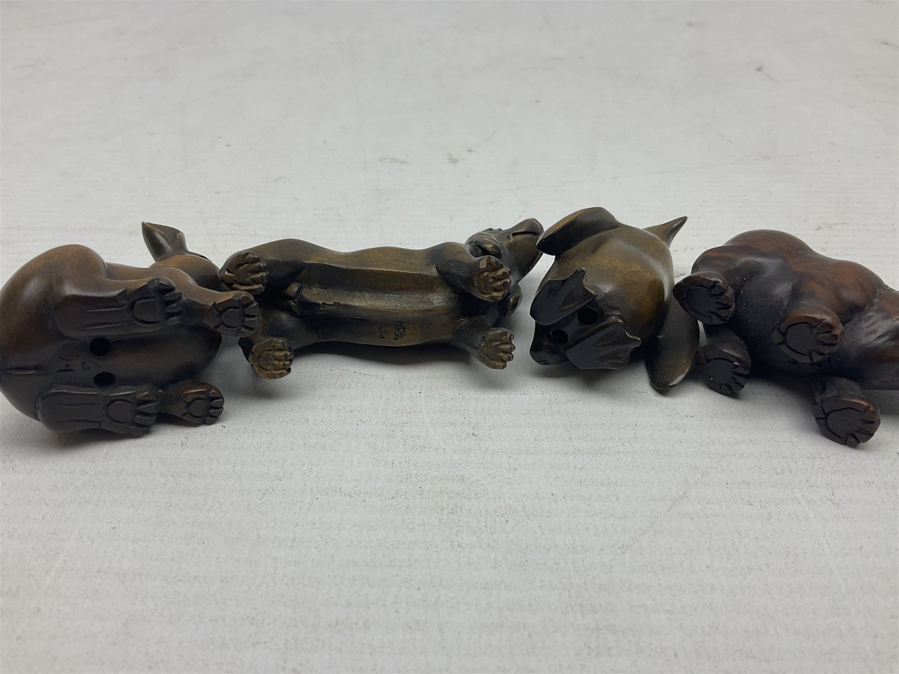 Eight netsuke, modelled as a rabbit, rat, elephant, rhino, dog, owl, penguin and horse