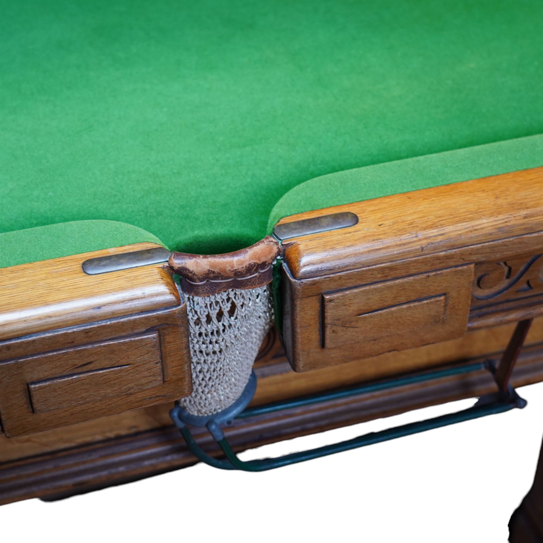 An outstanding bespoke late Victorian Aesthetic Movement golden oak full-sized snooker table of gothic influence, the rectangular slate bed covered in green baize within moulded rails and rounded pocket mounts, the protruding frame decorated with blind-fretwork frieze panels of Vitruvian scrolls and geometric ornament, over rails of repeating roundel carvings, raised on square chamfered and reeded supports with carved detail and panelled reserves, with further stylised brackets, stamped to the underside on all four edges R Anderson, serial number 4337
Viewing in situ near Tadcaster, please contact Chloe to arrange - 01904 393300