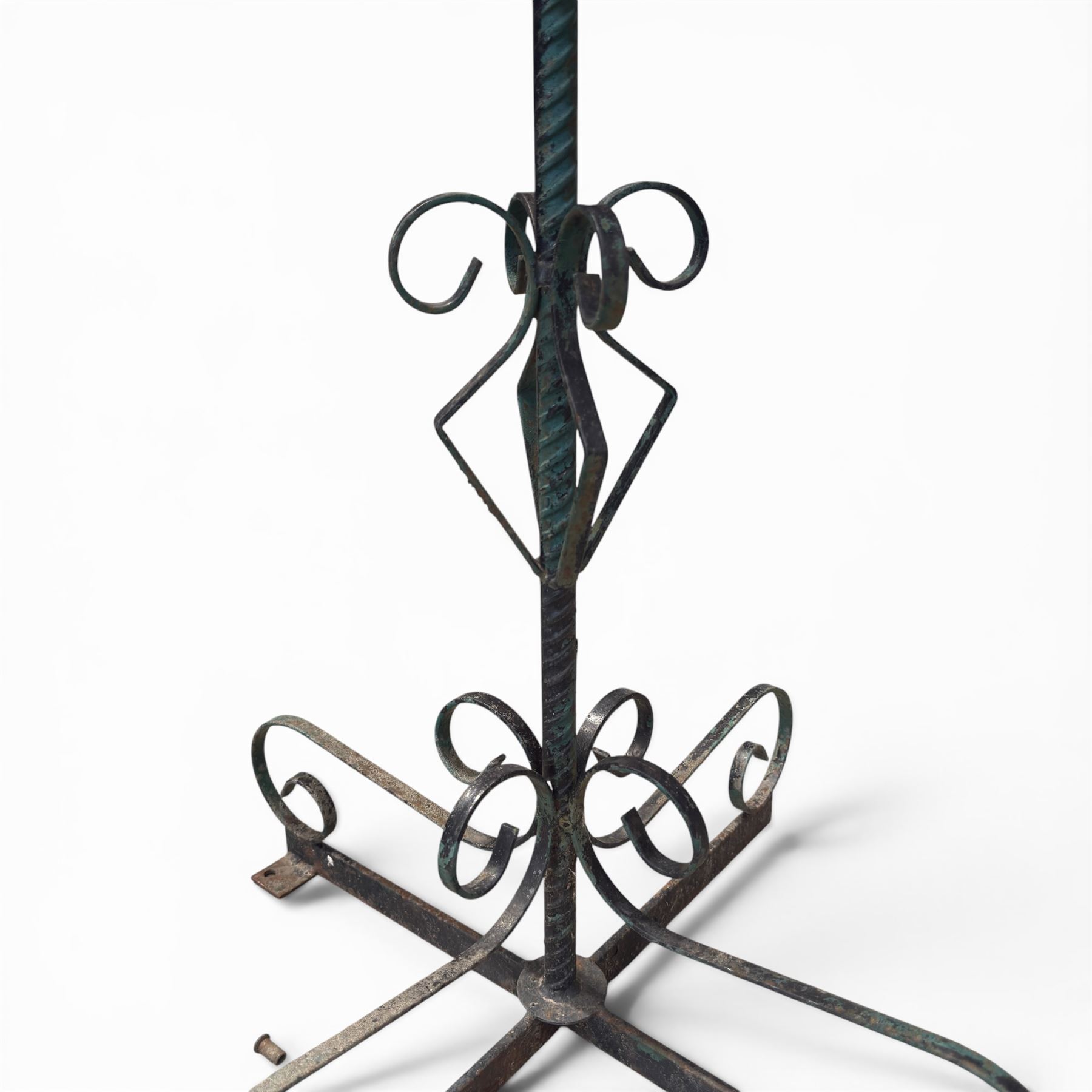 Matched pair of antique metal plant stands, each with circular strapwork basket tops, the scrollwork supports raised on an X-form base, in green painted finish with rustic patina