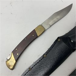 Indian large kukri with 39cm curving blade and horn grip; in leather covered scabbard L51cm overall; an 'Original Bowie Knife', the 15cm stainless steel blade decorated with bison; in black sheath; and a brass and hardwood folding knife with two blades (3)