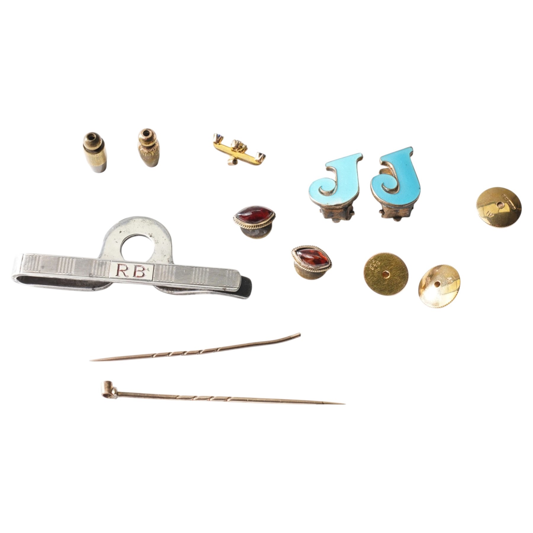 Pair of silver and enamel J clip on earrings, pair of gold cabochon garnet dress studs, silver money clip, gold dress stud and three backs, diamond set stick pin head etc 