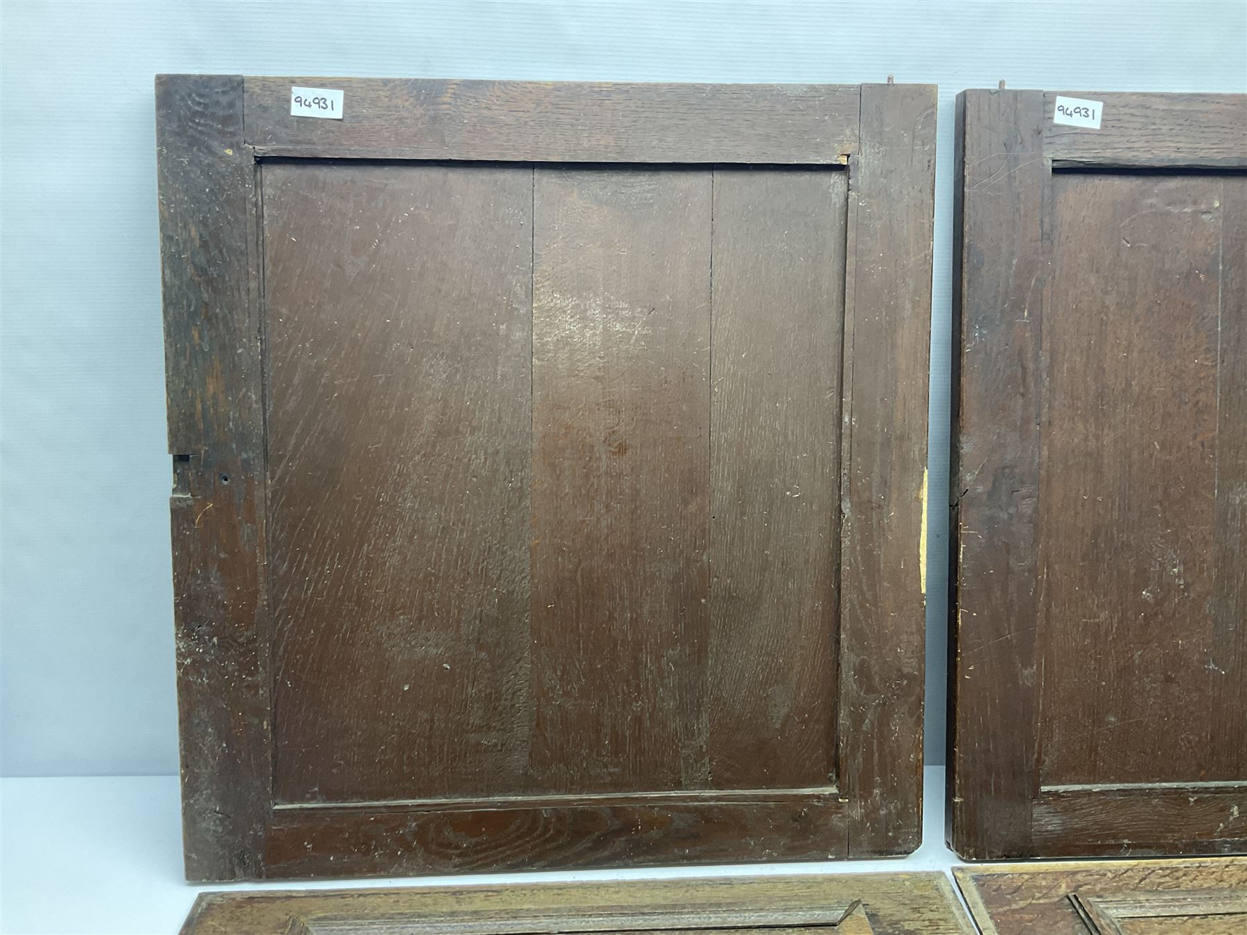 Pair of oak furniture door panels, carved in relief with a fox to one and a hound to the other, together with a pair of smaller oak panels, carved in relief with a hare to one and a grouse to the other, doors W63.cm x H62cm, panels W43cm x H60cm