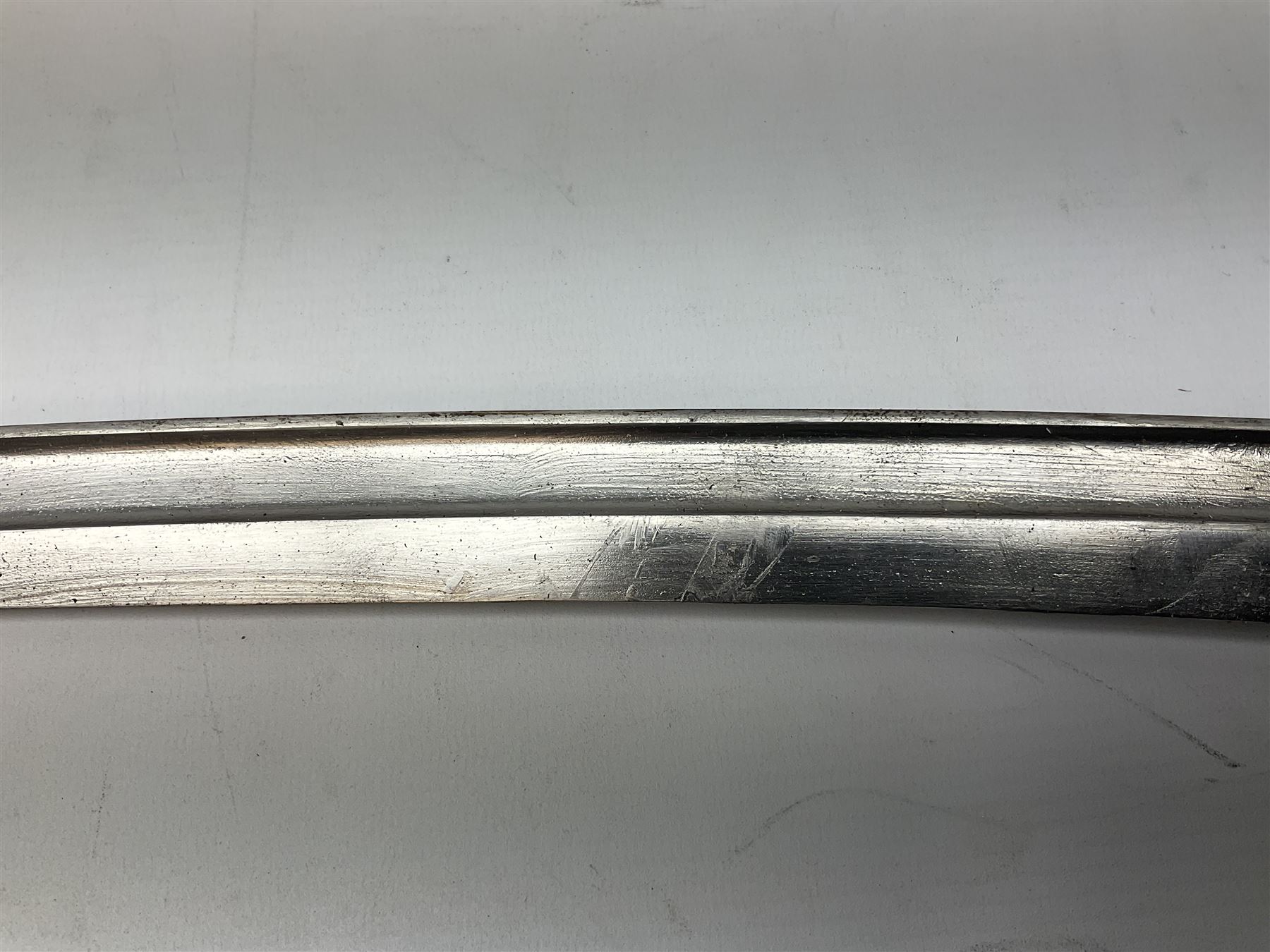 Turkish Model 1874 sword bayonet with 57.5cm curving steel fullered blade and chequered black grip, in steel mounted leather scabbard L75.5cm overall