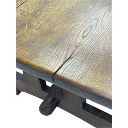 Early 20th century oak refectory dining table, rectangular top with rounded corners, twin pillar end supports on sledge platform and block feet, united by pegged stretcher 