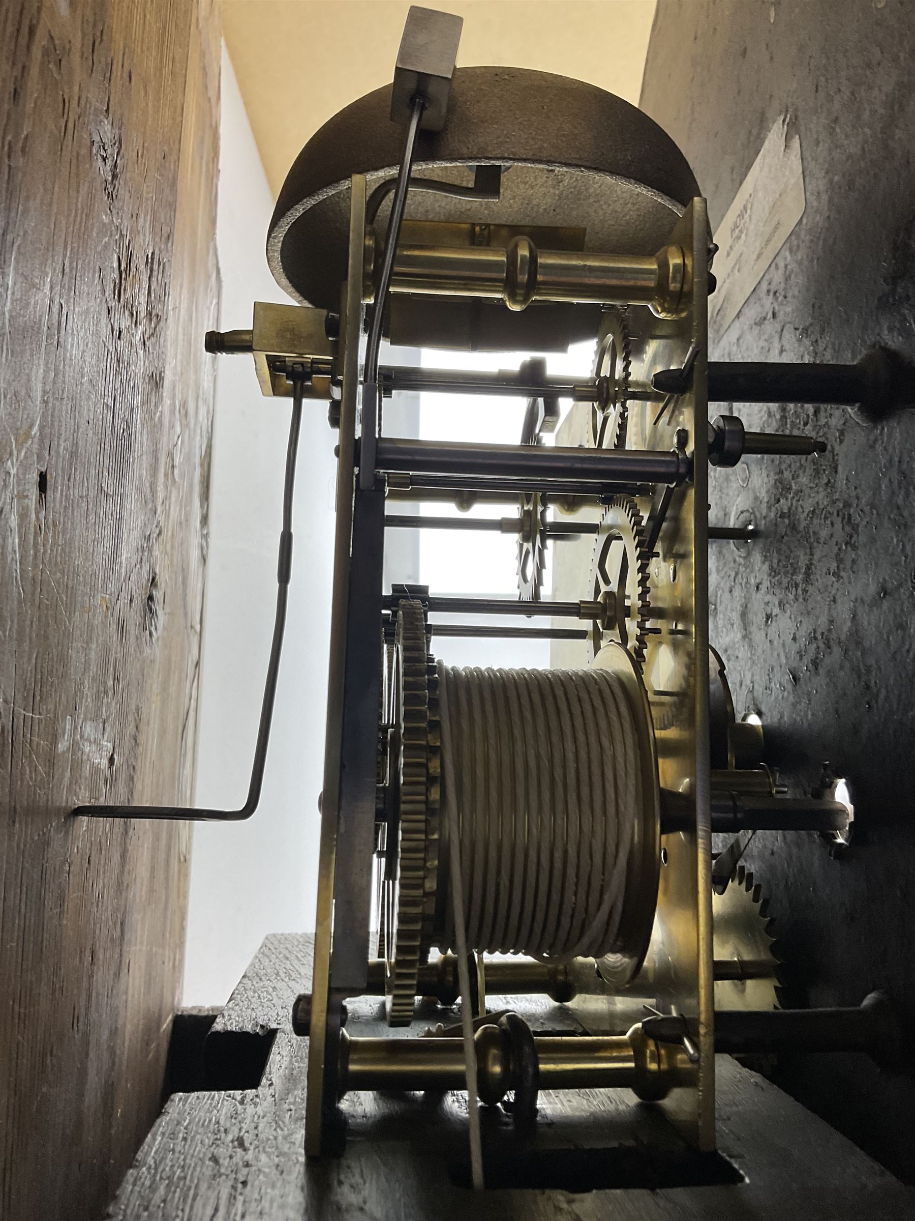 G Fortier of Sittingborn - Early 19th century 8-day mahogany longcase clock c1825, with a break arch pediment and hood door flanked by reeded pilasters with brass capitals, plain case with a long trunk door with a conforming break arch top, plinth with applied skirting, painted dial with upright Arabic numerals, date  and seconds dials, floral spandrels and a rural depiction of a country house and river to the arch, replacement steel hands with brass pointers to the calendar and seconds dials, dial pinned directly to a rack striking movement. With weights, pendulum and winding key.