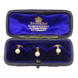Three gold shirt dress shirt studs set, each set with a pearl, stamped 18, in Brook & Son Edinburgh velvet and silk lined box