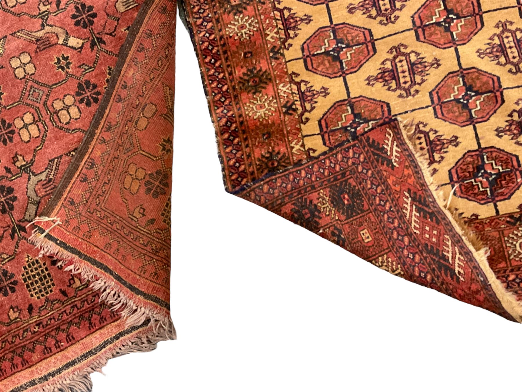Old Afghan red ground rug, decorated with repeating bird motifs, the guarded border with candelabra pattern (150cm x 104cm); and antique Afghan burnt orange ground rug, field decorated with octagonal lozenges, repeating geometric border (134cm x 95cm) (2)