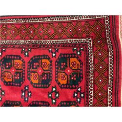 Two small Persian red ground rugs (122cm x 80cm and 111cm x 86cm)
