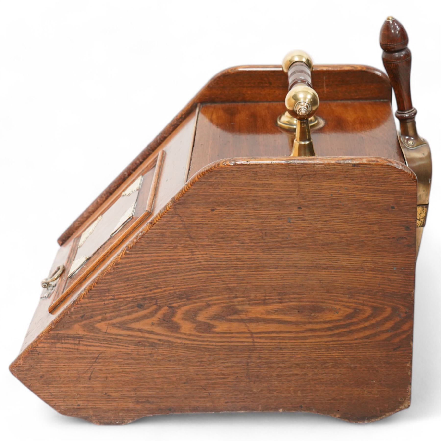 Late Victorian oak coal box, with brass mounted decoration, the hinged lid lifting to reveal removable interior lining, with scoop