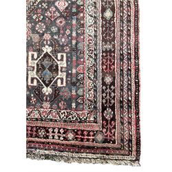 Persian Quashqai  rug, crimson ground extending lozenge on indigo ground field, decorated all over with stylised plant and bird motifs, the main border with repeating floral pattern within multiple geometric design guard bands