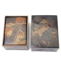 Nest of Japanese Meiji period lacquered boxes, the nashiji ground with maki-e decoration, each cover depicting a traditional landscape, the sides painted with traditional Japanese foliage, larger box H7cm (2)