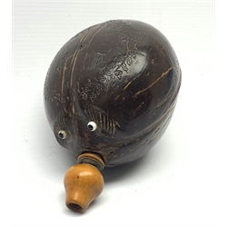 Napoleonic coconut bug bear flask with carved decoration and initials, inset glass eyes and turned boxwood pear shaped nozzle L17cm