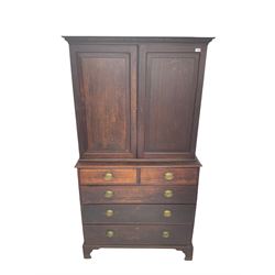 George III oak linen press, projecting cornice with dentil moulding over two panelled doors enclosing two adjustable shelves, fitted with two short over three long drawers, raised on bracket feet