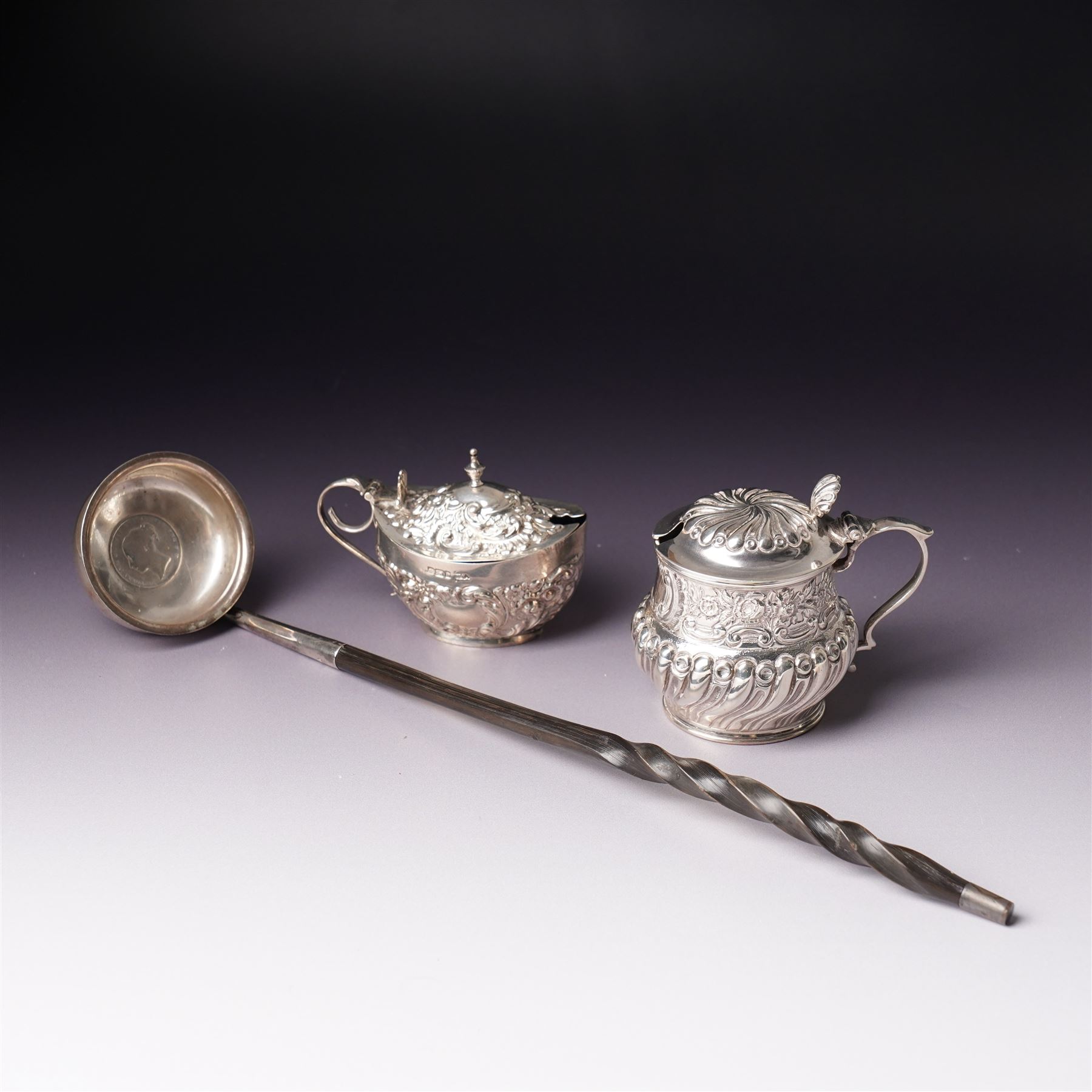 Victorian Scottish silver toddy ladle, the bowl inset with a Victorian shilling coin and with twisted whale bone handle Glasgow 1850 Maker Blaikley & Good, embossed silver drum mustard pot and and an oval mustard pot Sheffield 1902 (3)