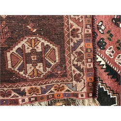 Shiraz red ground rug, three central medallions, 254cm x 177cm