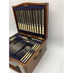 Late 19th/early 20th century composite canteen of silver flatware, contained within an early 20th century mahogany serpentine fronted case with twin drop carry handles, and hinged cover with boxwood stringing and central inlaid shell motif, above a single drawer with twin ring handles and Wellington style locking system, the cover and drawer opening to reveal plaque for Spink & Sons Ltd London, and fitted interior containing ivory handled knives, ivory handled carving set, and silver Hanoverian and Old English pattern cutlery, each with engraved monogram to terminal, hallmarked London, makers Spink & Son (John Marshall Spink), Goldsmiths & Silversmiths Co, and Chawner & Co (George William Adams), various dates ranging 1880-1923, gross weighable silver 92.59 ozt (2880 grams)