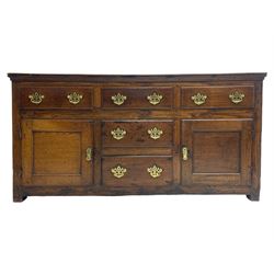 George III country oak dresser base,  rectangular top over with three central drawers flanked by two drawers and two panelled cupboards, each with moulded fronts, on stile feet