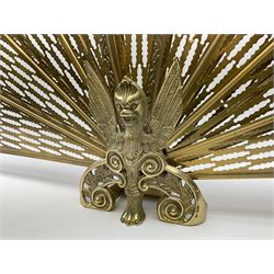 A brass peacock fire screen, with nine pierced fans, H53.5cm.