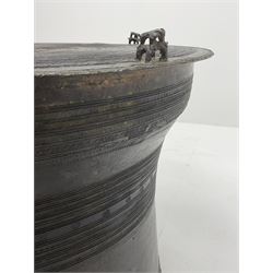 Dong Son style Southeast Asian bronze rain drum, the top decorated with concentric bands with stylised motifs and geometric shapes, central twelve point star, the tapered body with loop handles, set with small elephant and animal figures
