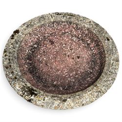 Weathered cast stone birdbath, the kylix shaped bowl with fluted body, raised on a fruiting foliate vine decorated fluted pedestal with upper knop and bird and fieldmouse motifs, shaped square base with scroll feet