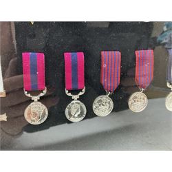Limited edition large framed display board with sixty half-size copies of British Gallantry and Campaign Medals produced by Danbury Mint; all with ribbons and associated booklet