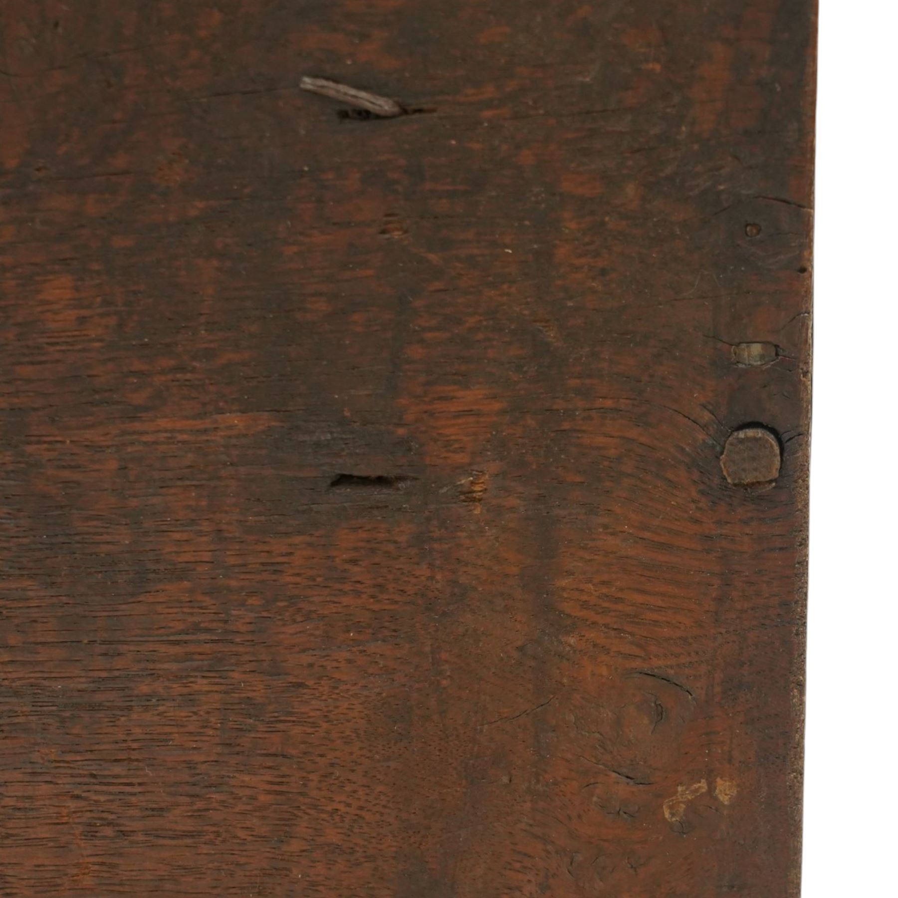 Small 17th century six plank oak coffer, figured top with iron pintle type hinges,  pegged boarded sides, large lock plate with rivets, plank ends continuing down as supports