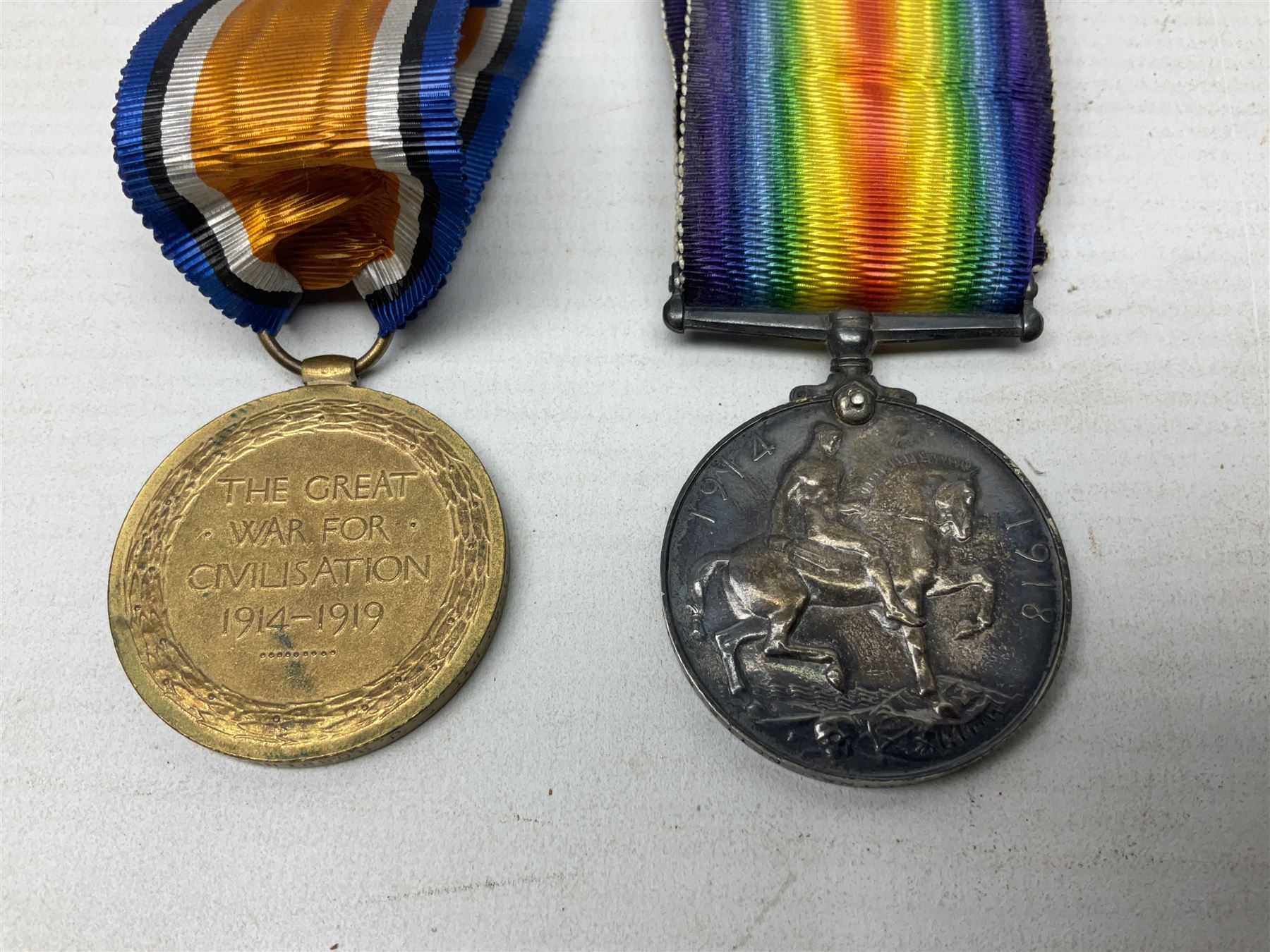 Pair of WWI medals, comprising British War medal and Victory medal, both with ribbons