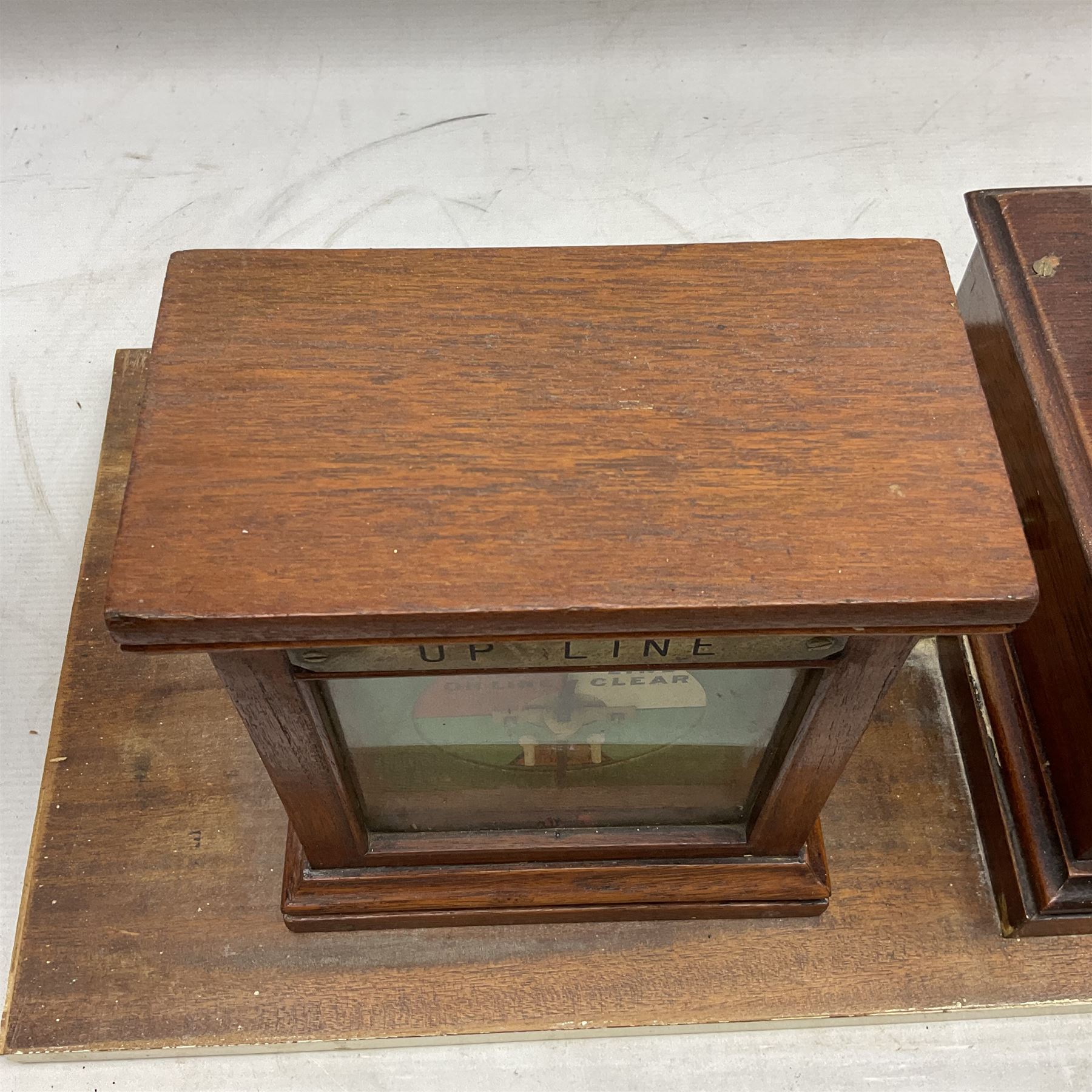 Railway signal boxes, mounted on plinth, with railway block indicators for Up Line and Down Line, having an electromagnetic indicator showing 'Train on Line' 'Line Clear' and 'Line Blocked', and brass signal bell to the centre, L100cm