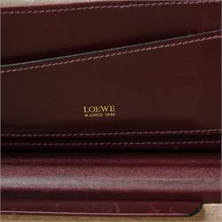Loewe - vintage burgundy leather attaché case, the exterior embossed with Loewe Anagram, with gilt-tone hardware, twin combination locks and leather handle, opening to a suede-lined fitted interior with document compartments, pen loops and pockets, stamped LOEWE Madrid 1846