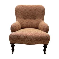 Late Victorian upholstered armchair, with high camel back and deep seat, padded arms and backrest in crimson and cream damask-style fabric, raised on turned ebonised front supports with ceramic castors (H88cm, W65cm, D 60m); and an Edwardian bedroom chair with button upholstered rail back (H72cm, D64cm, W53cm) (2)