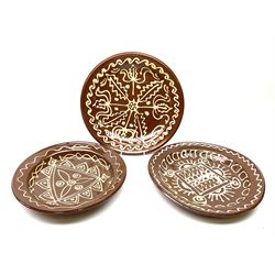 Three 20th century silpware dishes, of circular form decorated with geometric patterns, largest example D37cm, smallest example D33cm.
