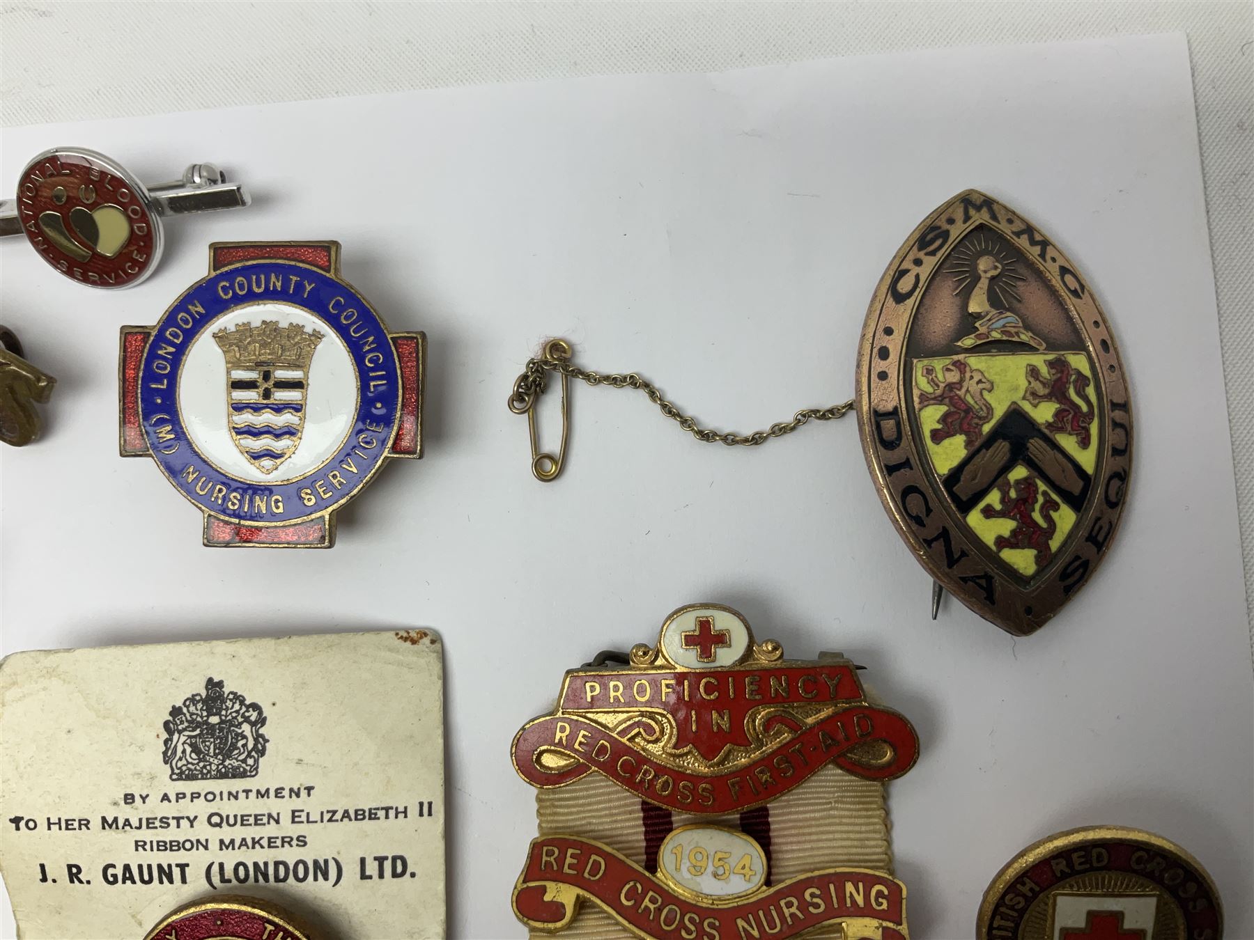 Collection of St John Ambulance enamel and metal badges, together with Red Cross medals and badges