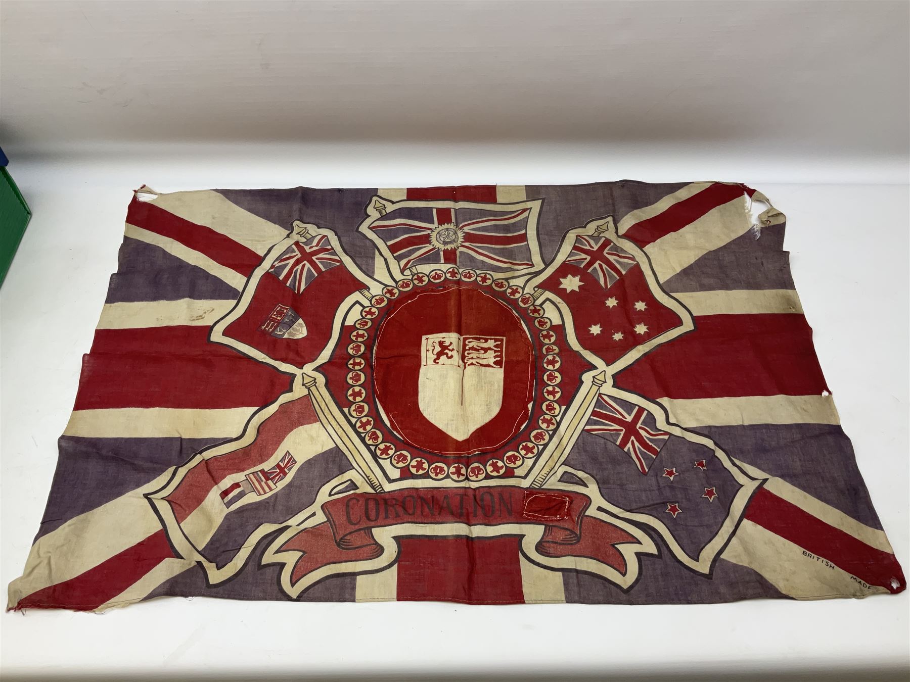 George VI 1937 Coronation flag, the central portrait and date covered with stitched panels 56 x 83cm; sailor's hat; leather holster with belt dated 1943 containing Lone Star toy die-cast Luger gun; and reproduction Stanley brass cased pocket sextant (4)