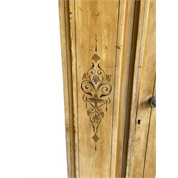 19th century painted pine wardrobe, the projecting cornice over mirror glazed door, with painted decoration depicting scrolling foliate and urns, drawer to base on skirt