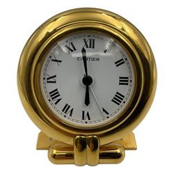 Cartier, Pasha de Cartier desk/travel clock, of circular form with gilt finish and white dial, with quartz movement, inscribed verso Made in France, Cartier Paris, serial no 0541616, dial D5cm, clock H9.7cm